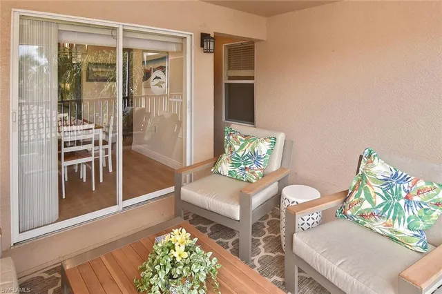 a dining room with furniture a rug and a chandelier