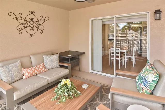 a dining room with furniture a chandelier and wooden floor