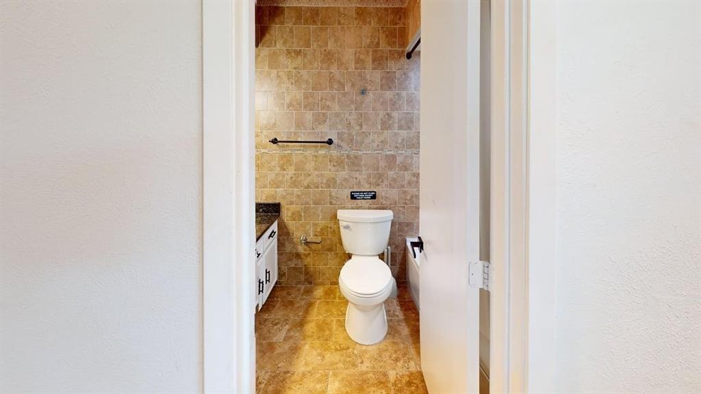 2131 Blossom Lane Richardson, TX 75081 - Photo 16 of 22 a bathroom with a toilet