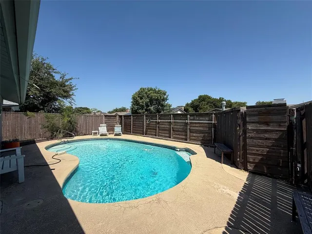 a view of a swimming pool with a lounge chairs