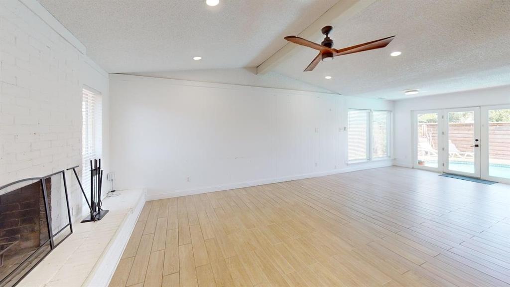 2131 Blossom Lane Richardson, TX 75081 - Photo 6 of 22 a view of a room with wooden floor and a ceiling fan