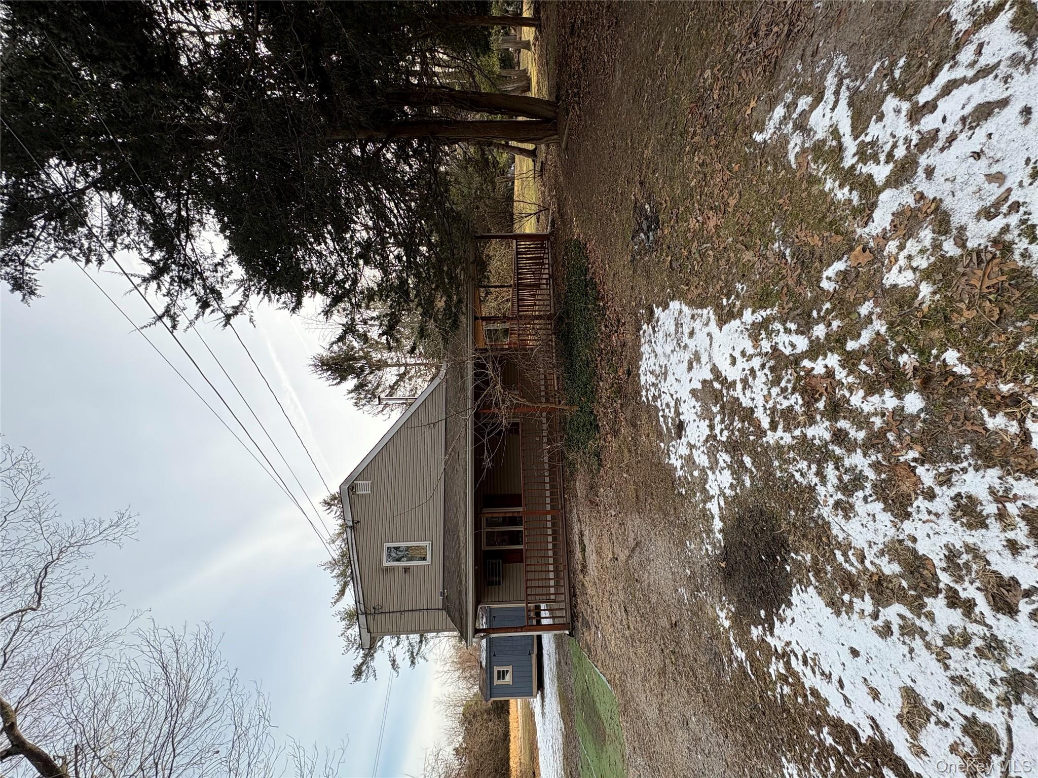 58 Coram Swezeytown Road Middle Island, NY 11953 - Photo 19 of 26 a front view of a house with a yard