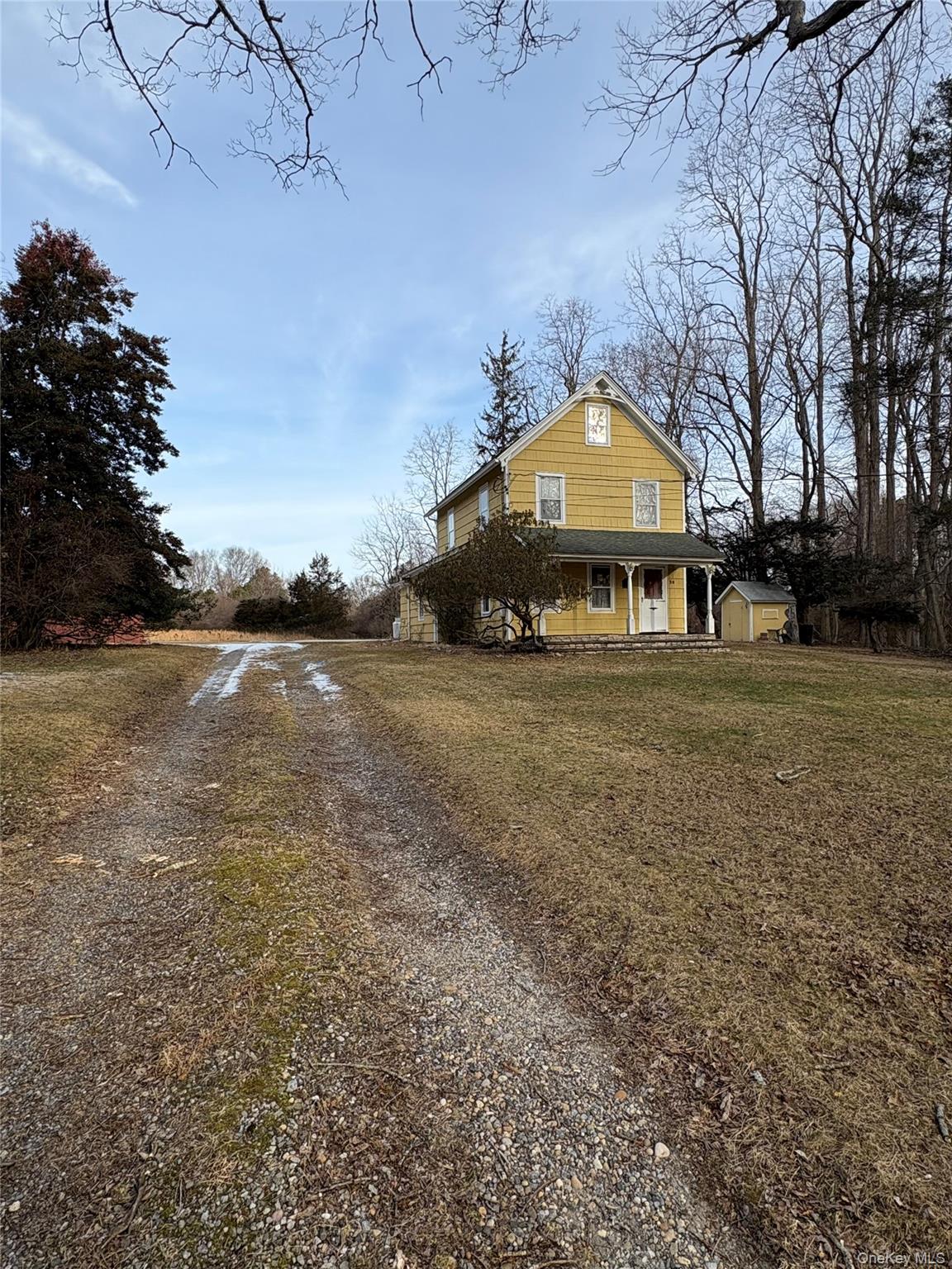 58 Coram Swezeytown Road Middle Island, NY 11953 - Photo 2 of 26 a front view of a house with a yard