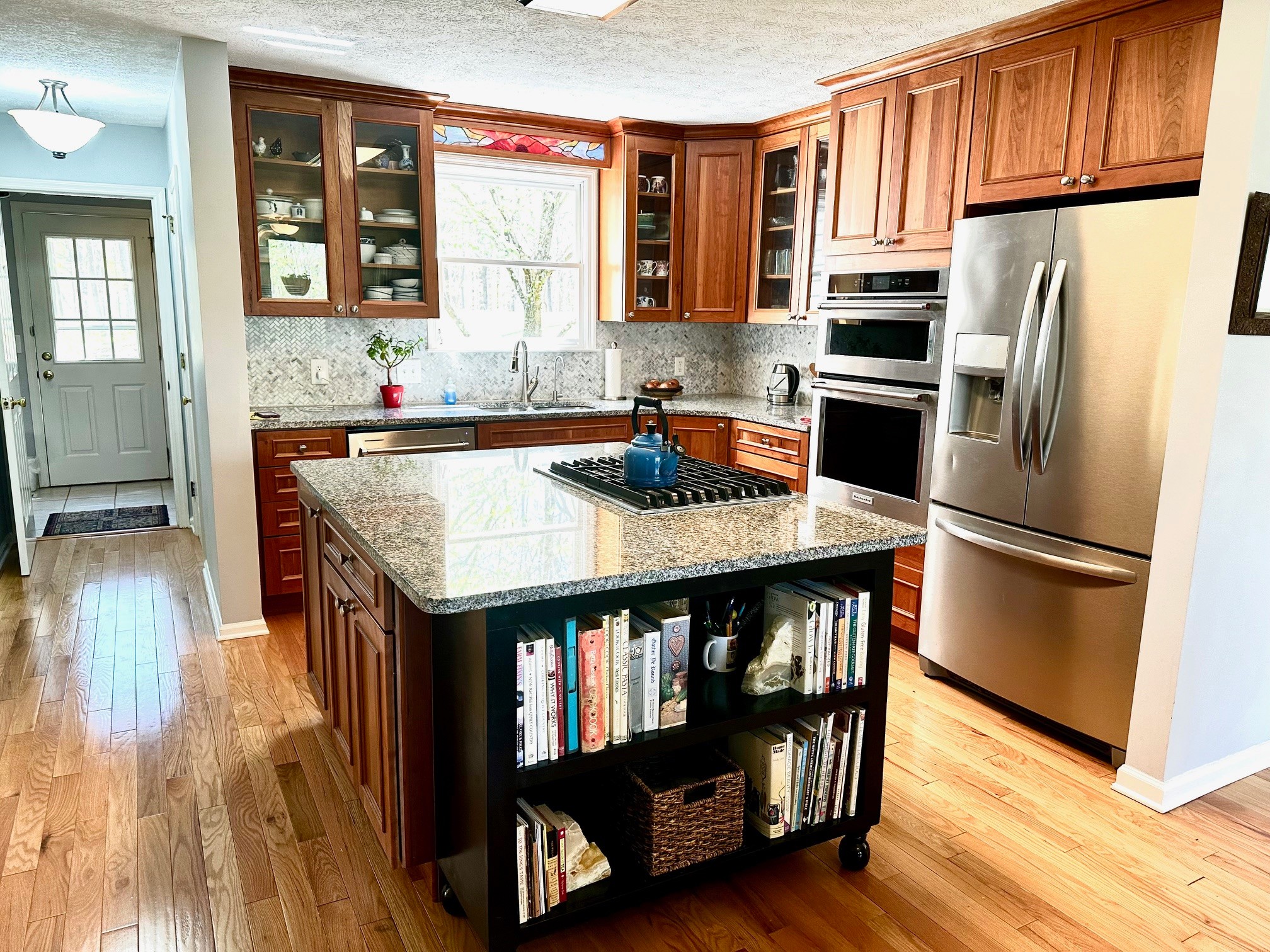 5292 Old Harding Road Franklin, TN 37064 - Photo 12 of 25 a kitchen with granite countertop a refrigerator a stove and a wooden floor
