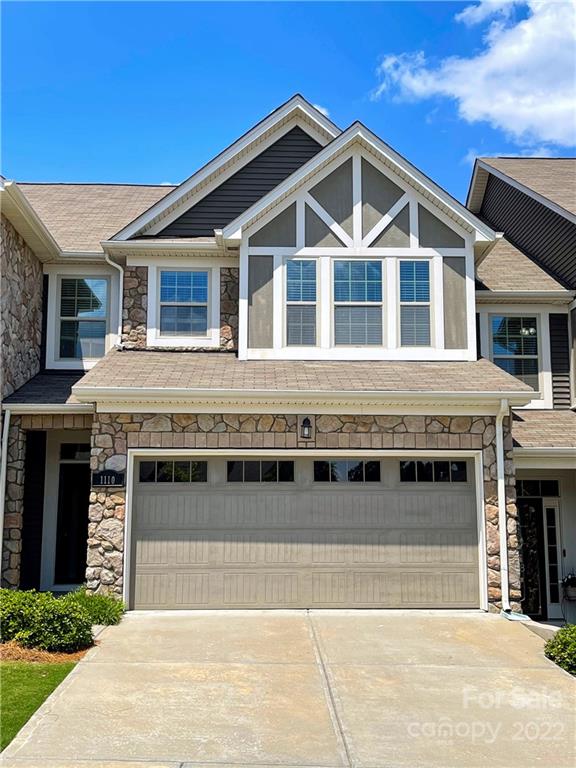 a front view of a house with a garage