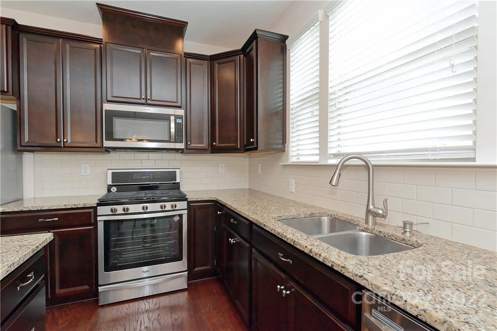 1110 Roderick Drive Fort Mill, SC 29708 - Photo 11 of 37 a kitchen with granite countertop cabinets stainless steel appliances a sink and window