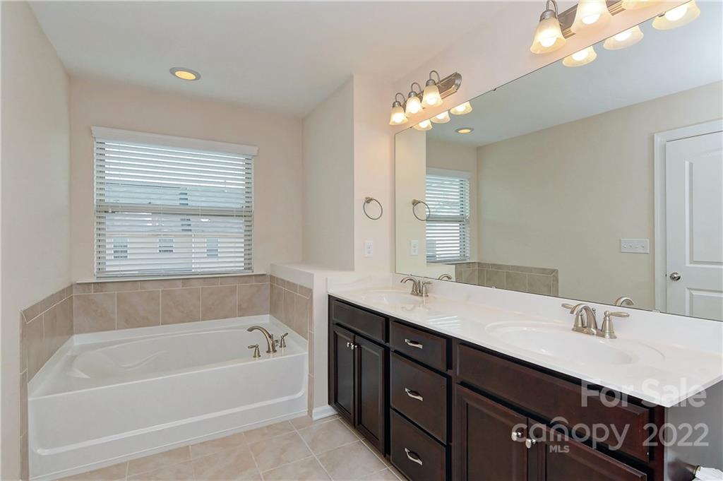 1110 Roderick Drive Fort Mill, SC 29708 - Photo 20 of 37 a bathroom with a tub a sink double vanity granite and a bathtub