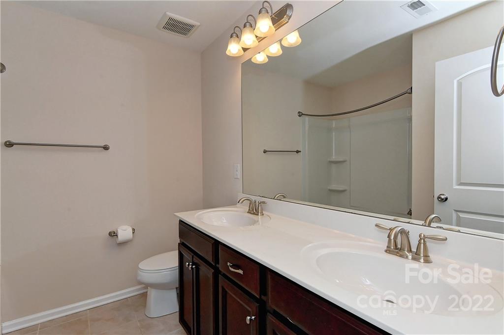 1110 Roderick Drive Fort Mill, SC 29708 - Photo 25 of 37 a bathroom with a sink a toilet and a mirror