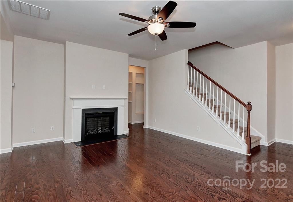 1110 Roderick Drive Fort Mill, SC 29708 - Photo 6 of 37 a view of a livingroom with a fireplace a ceiling fan and a kitchen view