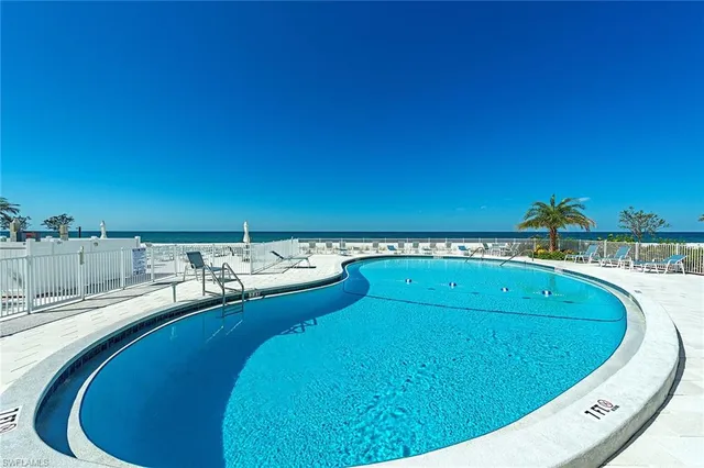 a view of a swimming pool with a lounge chair