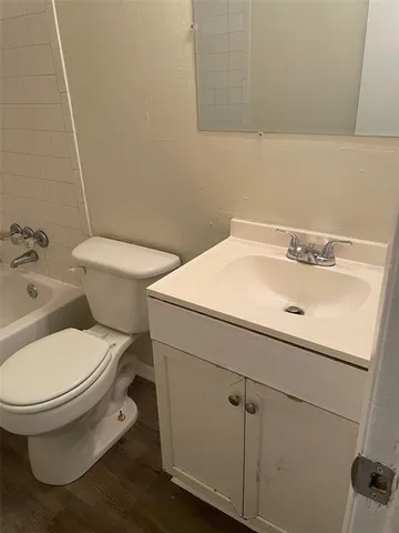 a white toilet sitting next to a bathroom sink