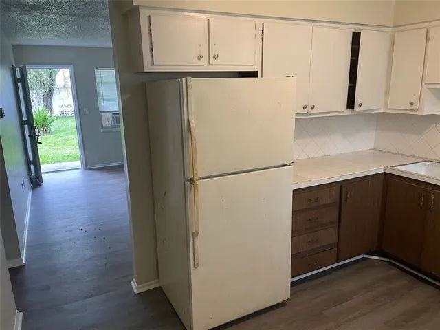 a view of cabinets with wooden floor