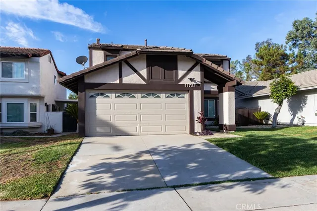 a front view of a house with garage