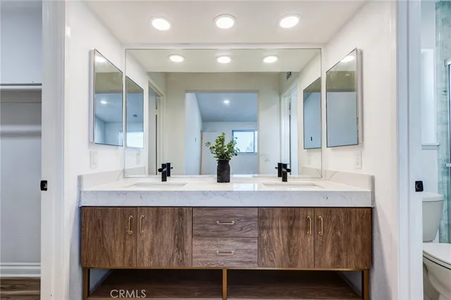 a view of a room with wooden floor and white walls