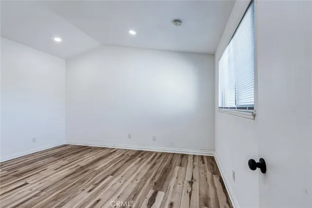 a view of a room with wooden floor and white walls