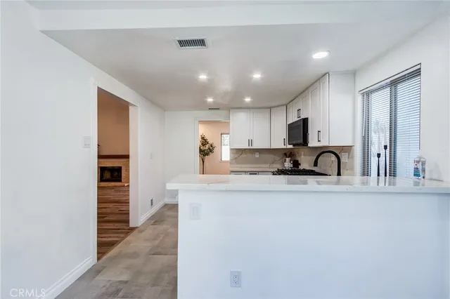 a kitchen with stainless steel appliances granite countertop a sink and cabinets