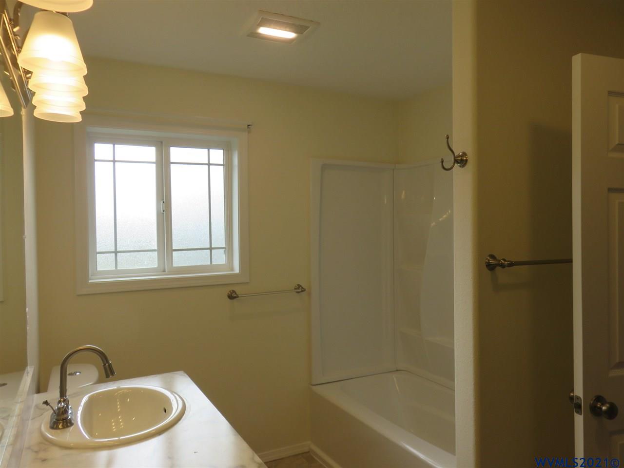 18990 Falls City Road Dallas, OR 97338 - Photo 19 of 42 a bathroom with a granite countertop sink toilet and shower