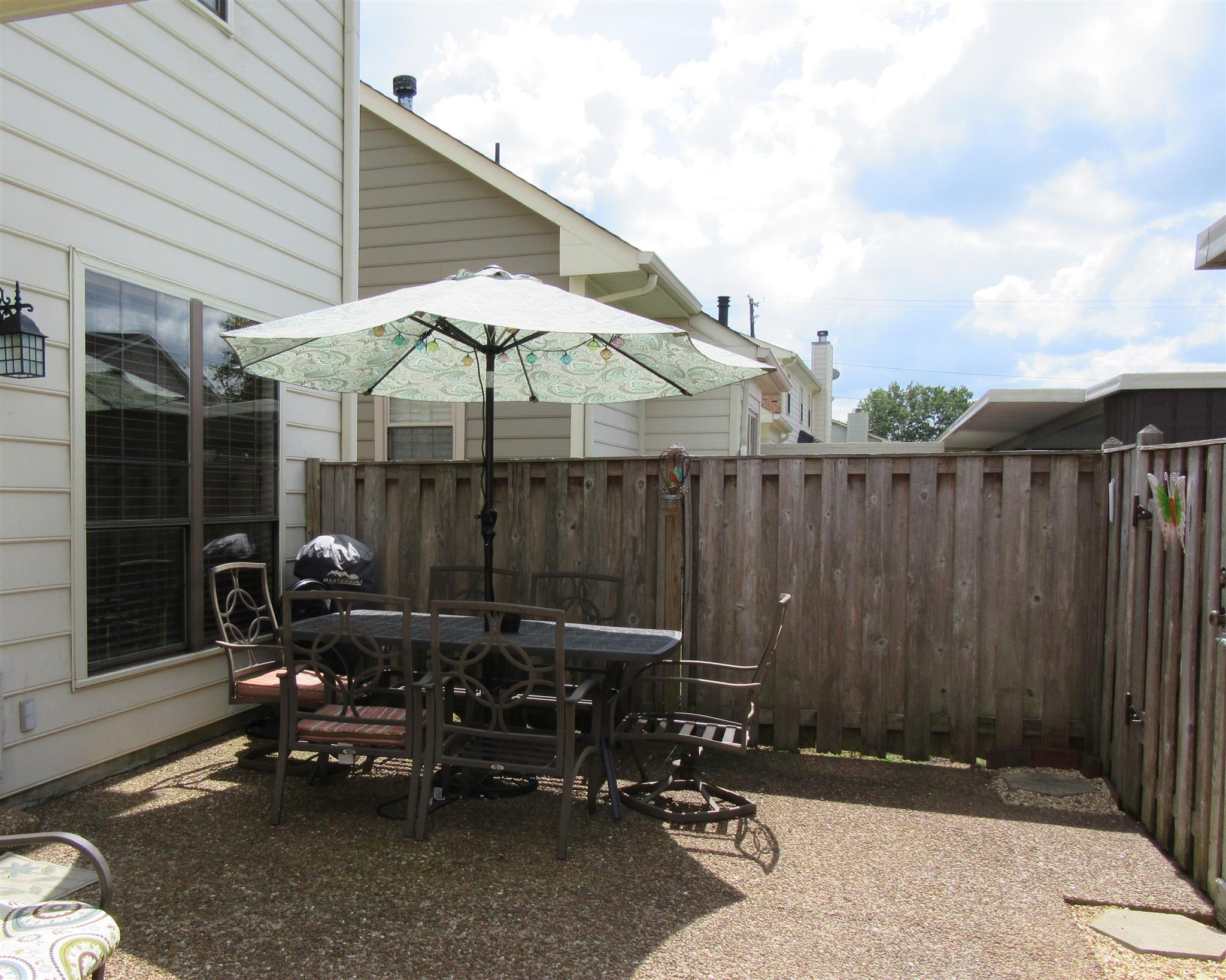 1252 General George Patton Road Nashville, TN 37221 - Photo 22 of 30 a backyard of a house with table and chairs