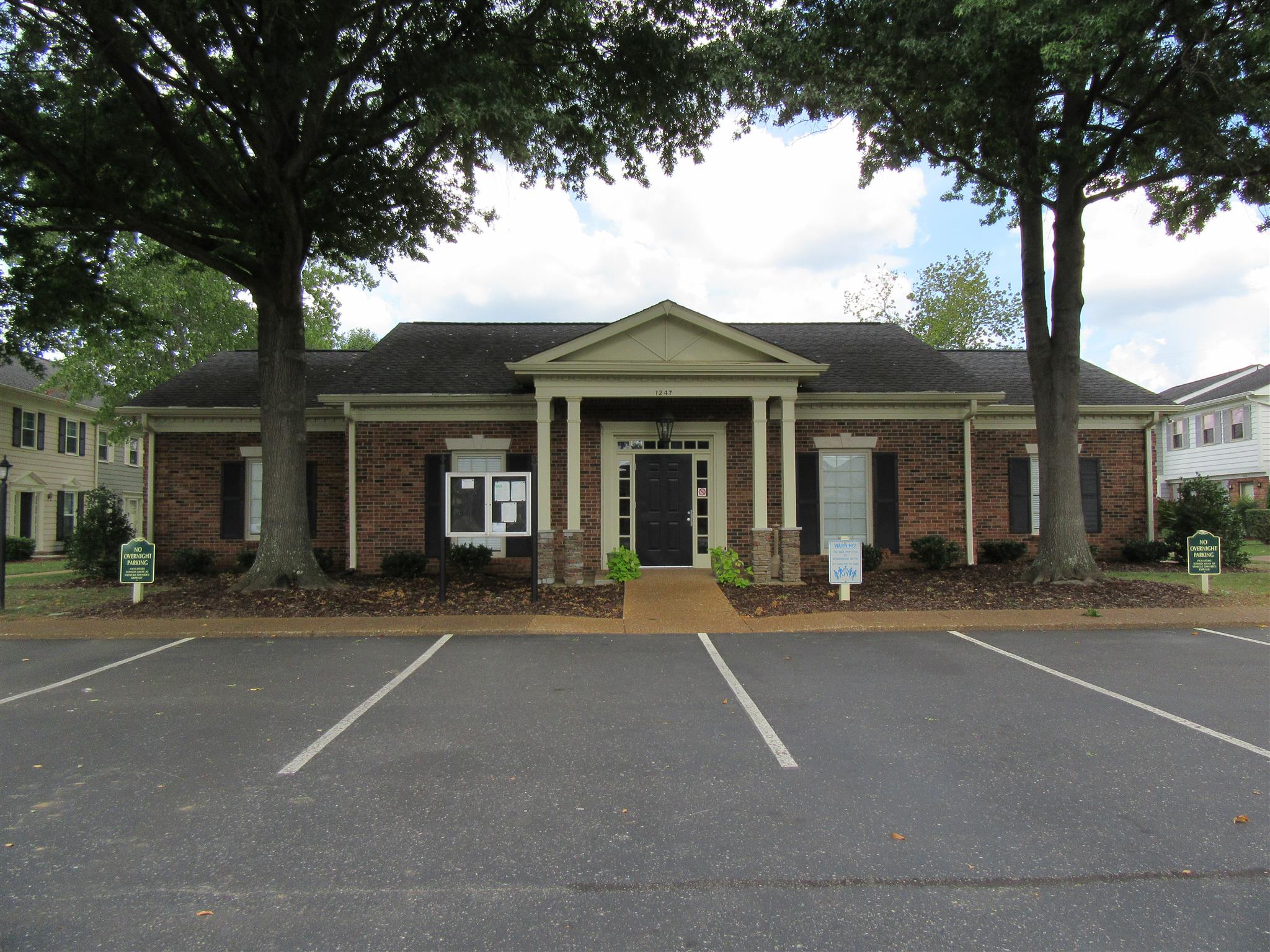 1252 General George Patton Road Nashville, TN 37221 - Photo 25 of 30 a front view of a house with a garden and trees