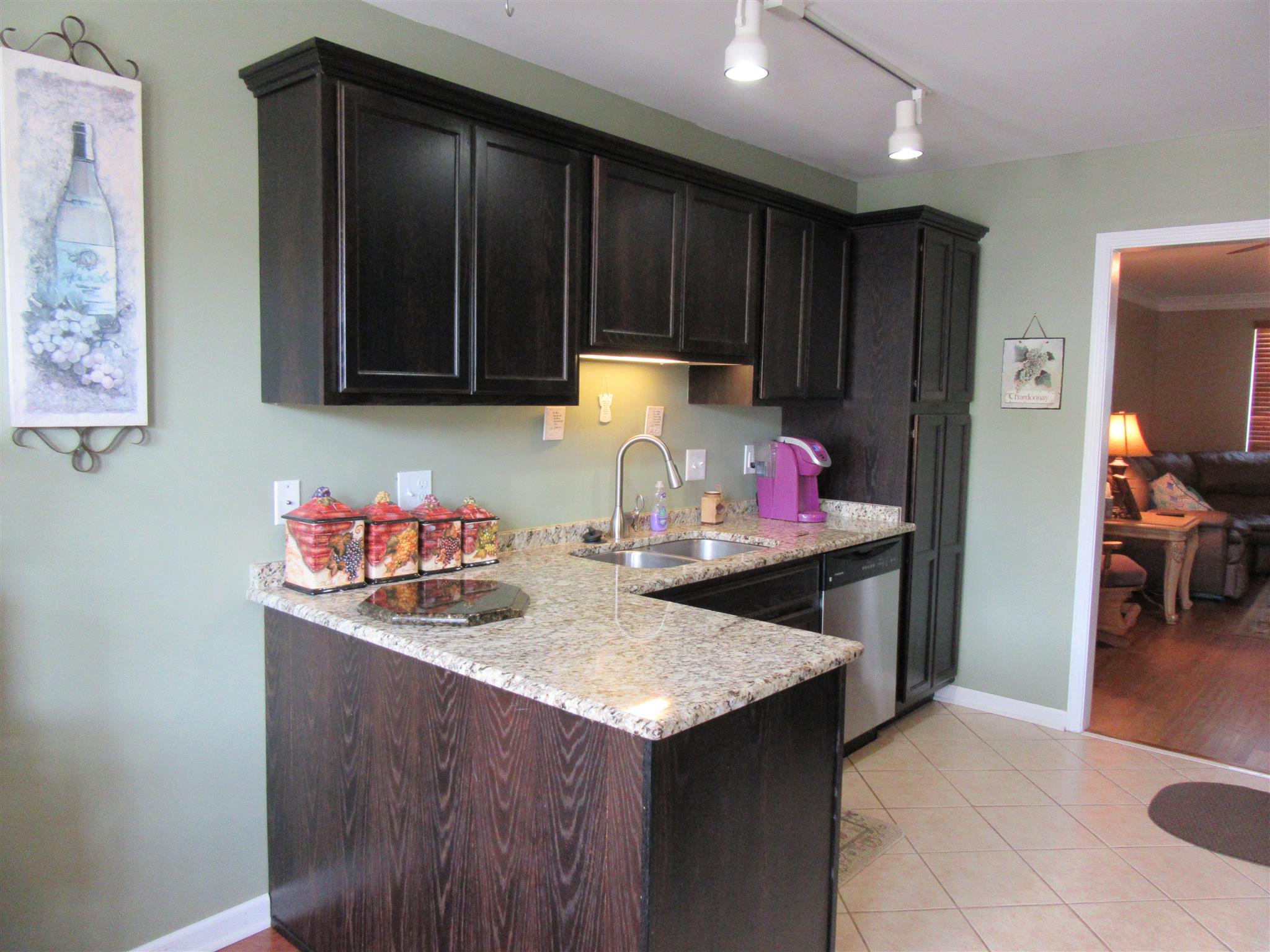 1252 General George Patton Road Nashville, TN 37221 - Photo 7 of 30 a kitchen with granite countertop cabinets and stove