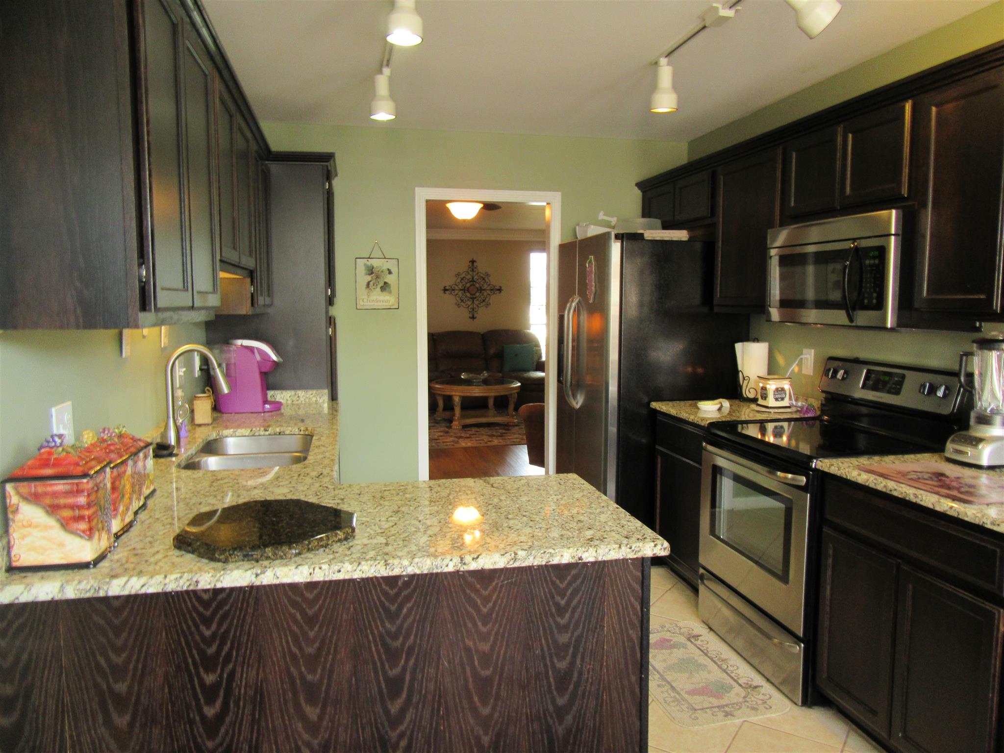 1252 General George Patton Road Nashville, TN 37221 - Photo 8 of 30 a kitchen with stainless steel appliances granite countertop a sink stove and refrigerator