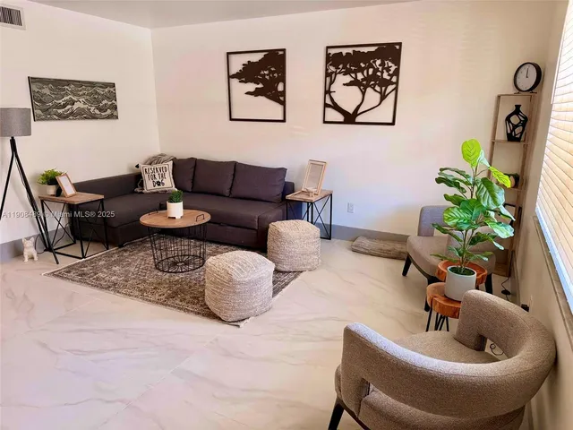 a living room with furniture and flowers