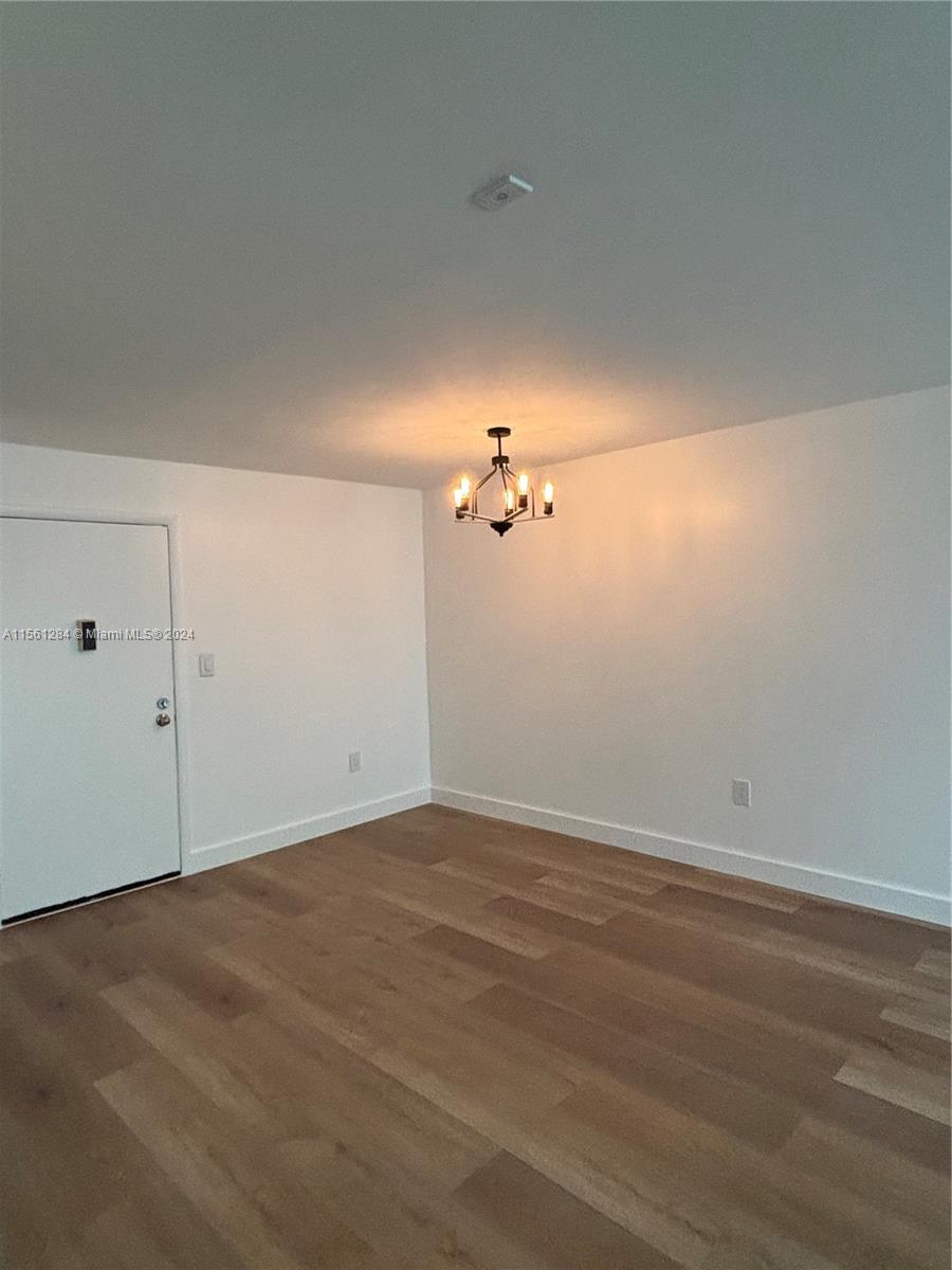 a view of room with hardwood floor