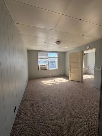 a view of a big room with windows and cabinet