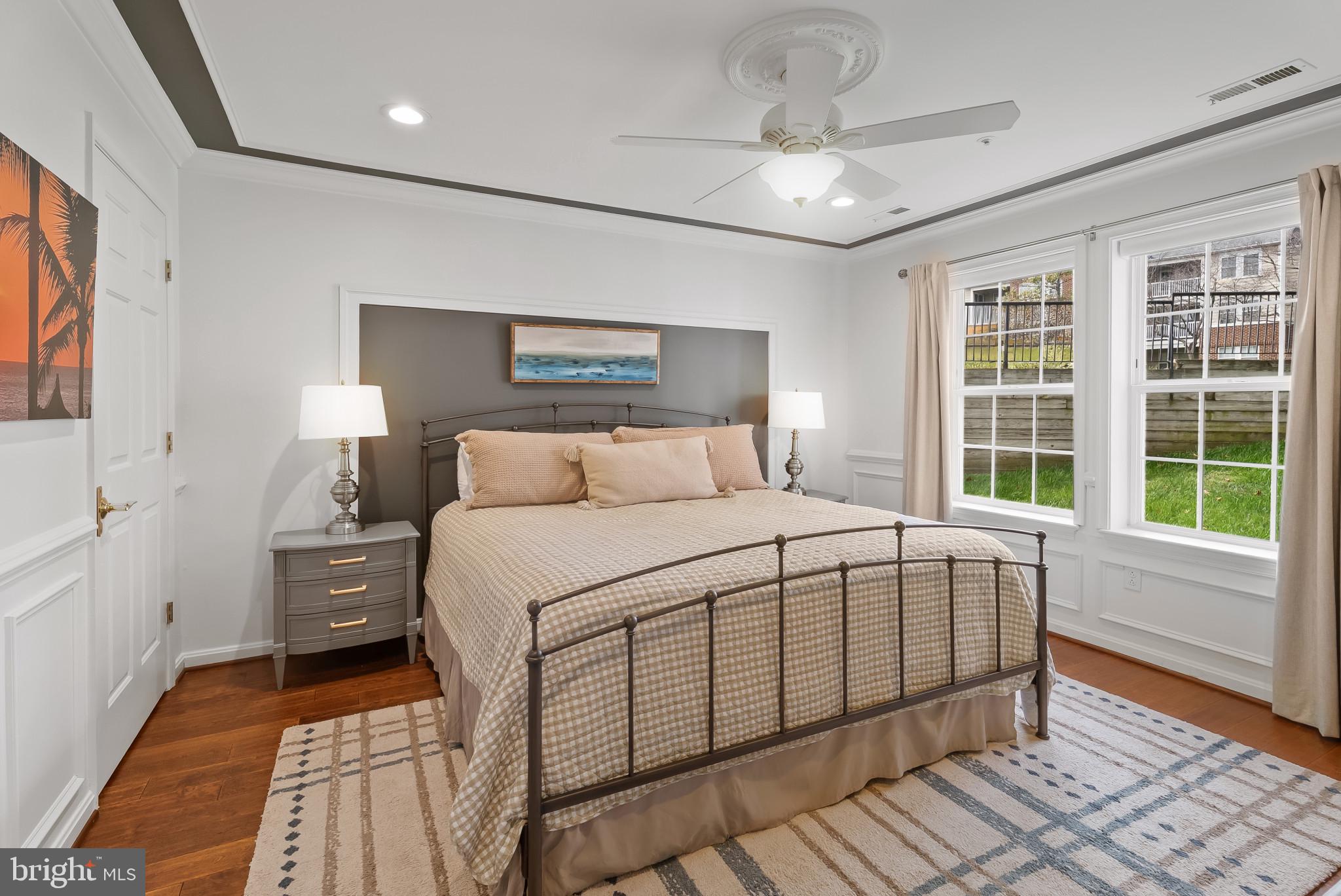 2406 Dominion Drive, Unit 1B Frederick, MD 21702 - Photo 13 of 30 a bedroom with a large bed and a chandelier