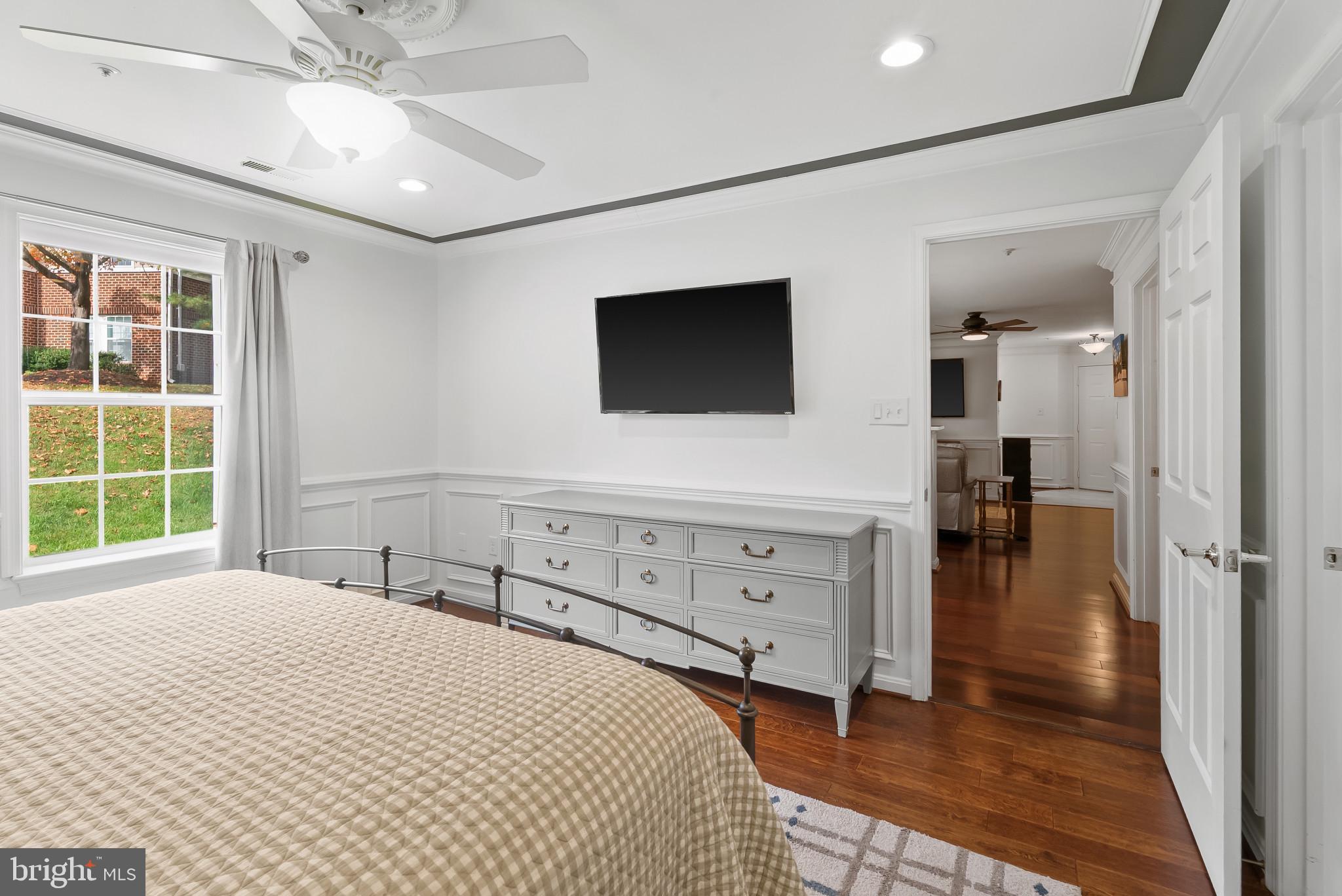 2406 Dominion Drive, Unit 1B Frederick, MD 21702 - Photo 15 of 30 a bedroom with a bed and a flat tv screen on dresser
