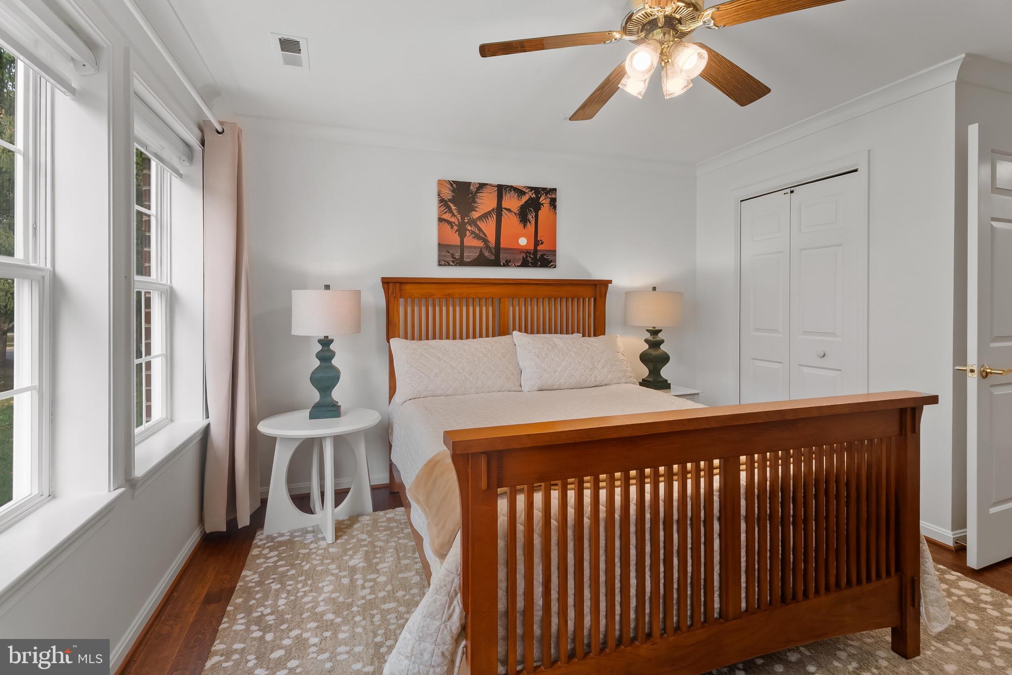 2406 Dominion Drive, Unit 1B Frederick, MD 21702 - Photo 20 of 30 a bedroom with a bed and a chandelier