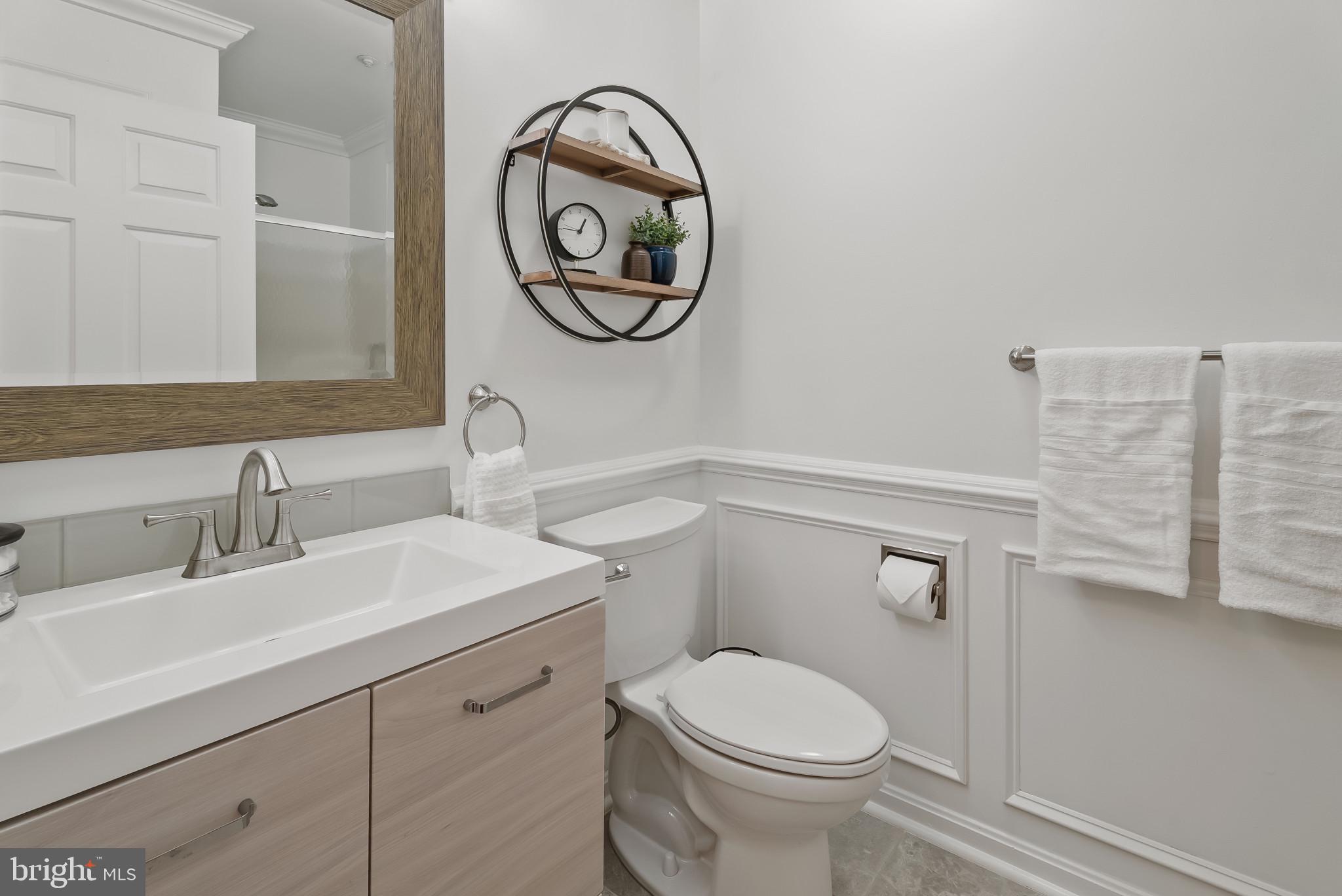 2406 Dominion Drive, Unit 1B Frederick, MD 21702 - Photo 21 of 30 a bathroom with a toilet a sink and a mirror