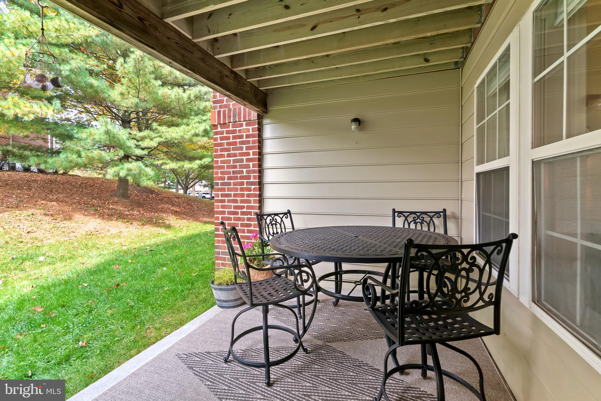 2406 Dominion Drive, Unit 1B Frederick, MD 21702 - Photo 22 of 30 a patio with table and chairs and potted plants