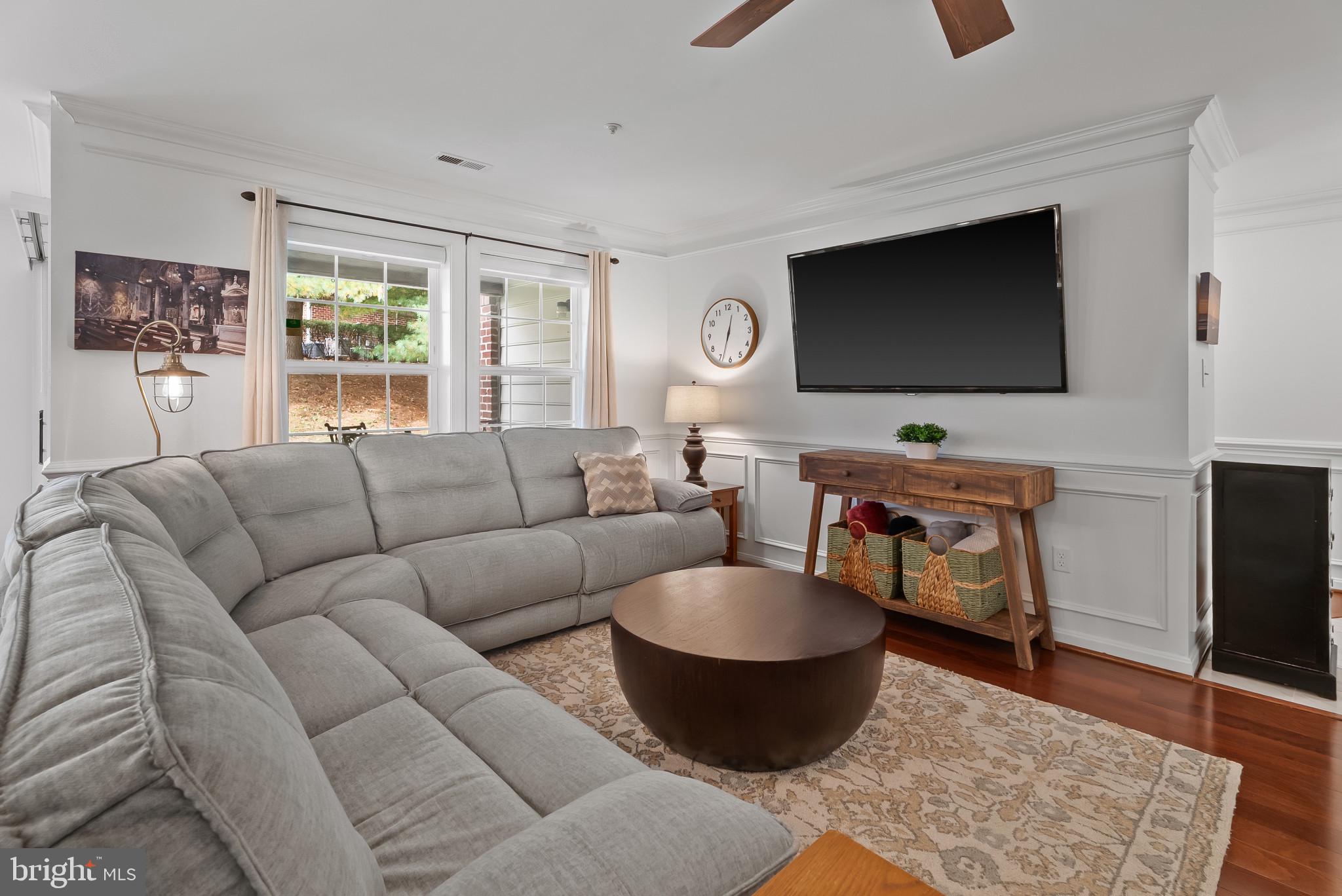 2406 Dominion Drive, Unit 1B Frederick, MD 21702 - Photo 6 of 30 a living room with furniture a flat screen tv and a large window
