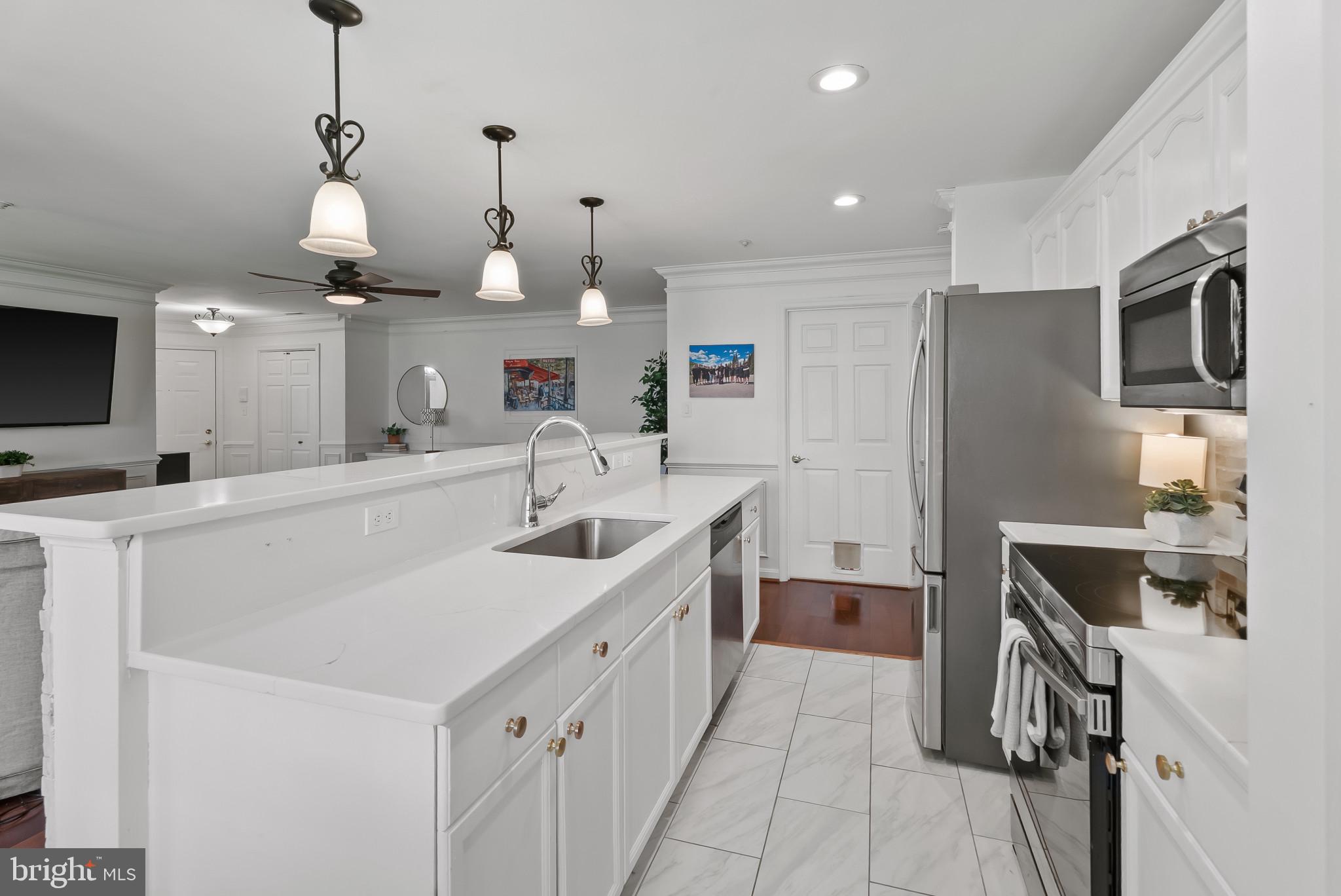 2406 Dominion Drive, Unit 1B Frederick, MD 21702 - Photo 9 of 30 a kitchen with a sink appliances and cabinets