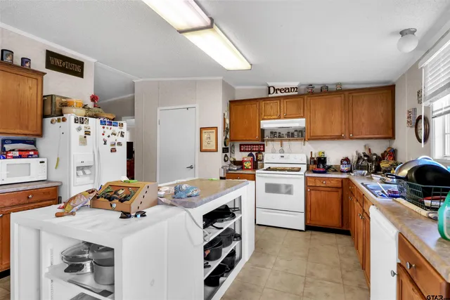 a kitchen with a stove a sink and a refrigerator