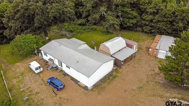 an aerial view of a house with backyard