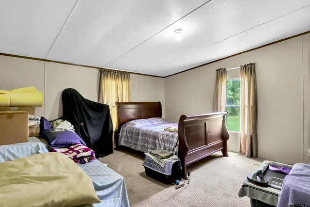 a bedroom with bed and a window