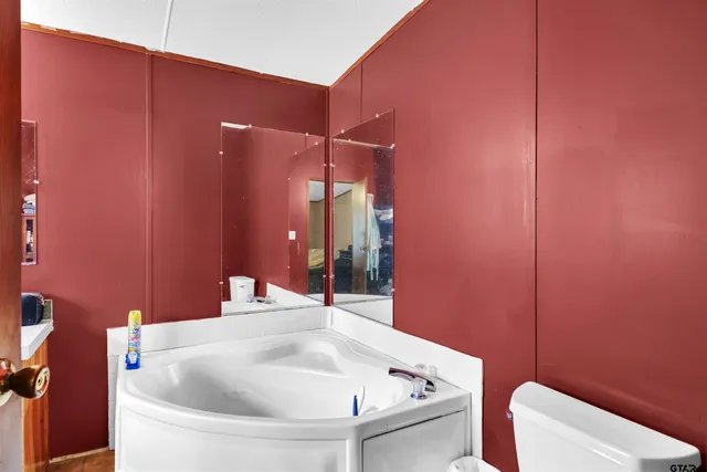 a bathroom with a white bath tub and a sink