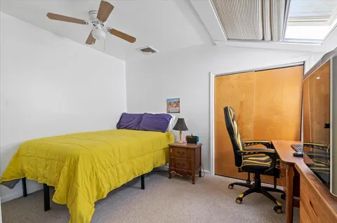 a bed sitting in a room next to a window