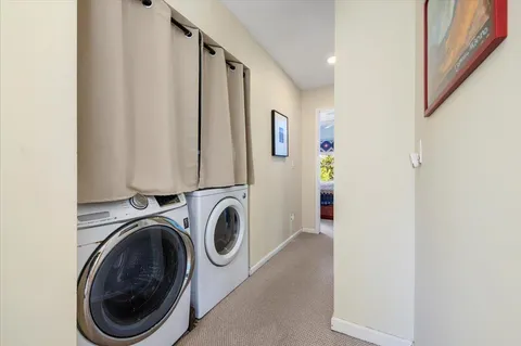 a view of a hallway with washer and dryer