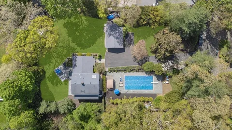 an aerial view of a house with a yard