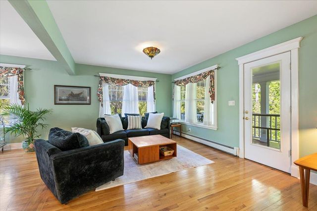 a living room with furniture and large windows
