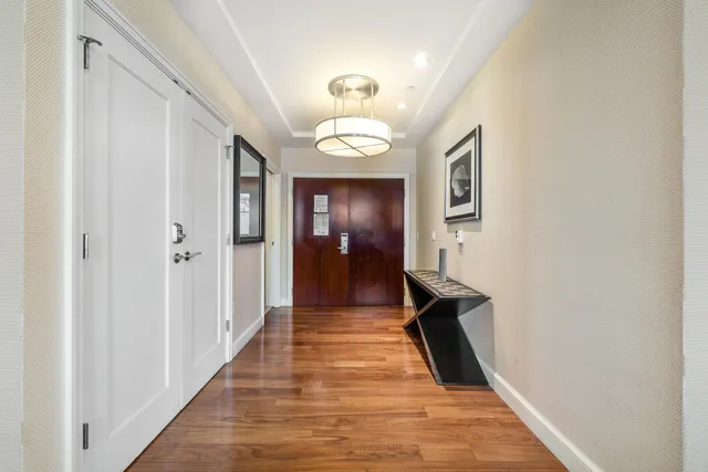 a view of a hallway with wooden floor and staircase