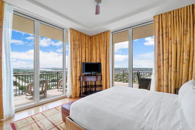 a bedroom with a large window and a bed