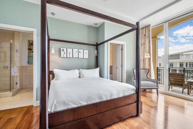 a bedroom with a large bed and a chandelier