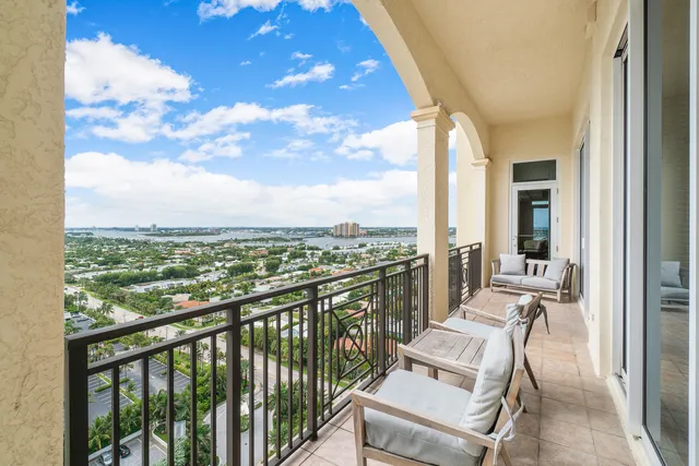 a balcony with furniture and large glass door
