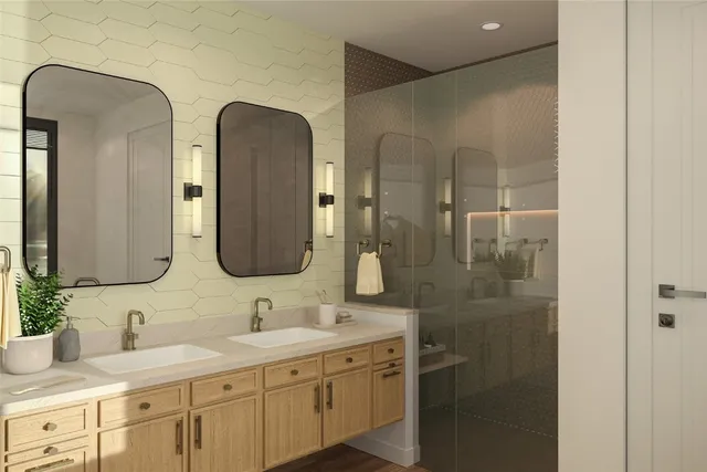 a bathroom with double vanity sinks and a mirror