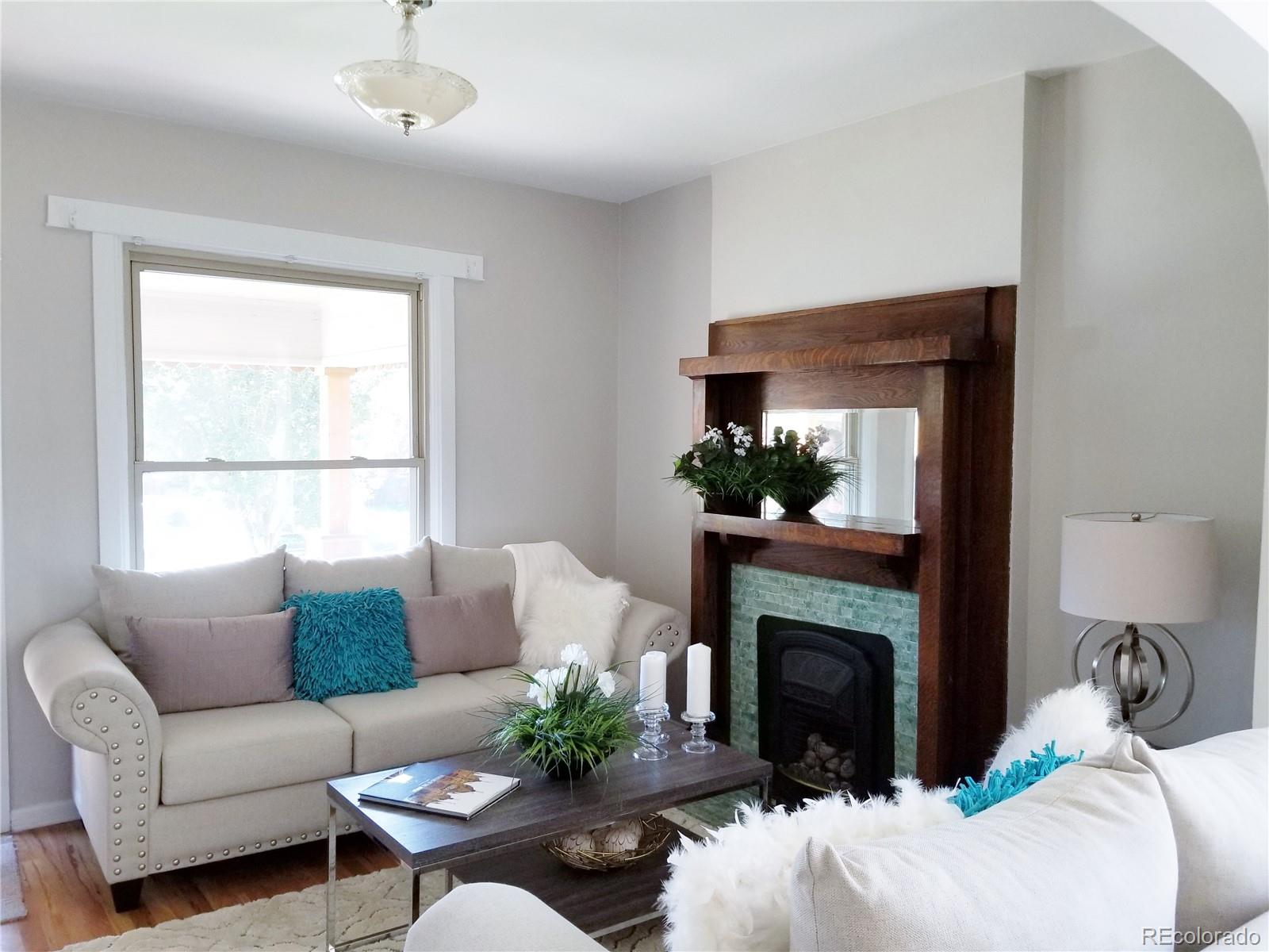 4307 Decatur Street Denver, CO 80211 - Photo 3 of 13 a living room with furniture a window and a fireplace