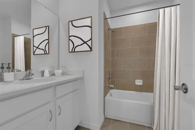 a bathroom with a tub a sink and mirror